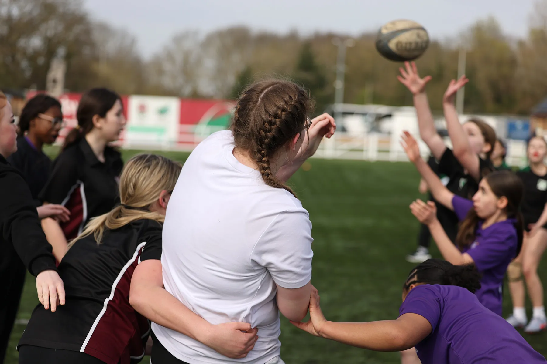 Female students playing rugby.